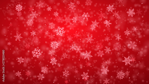 Christmas background of complex blurred and clear falling snowflakes in red colors with bokeh effect