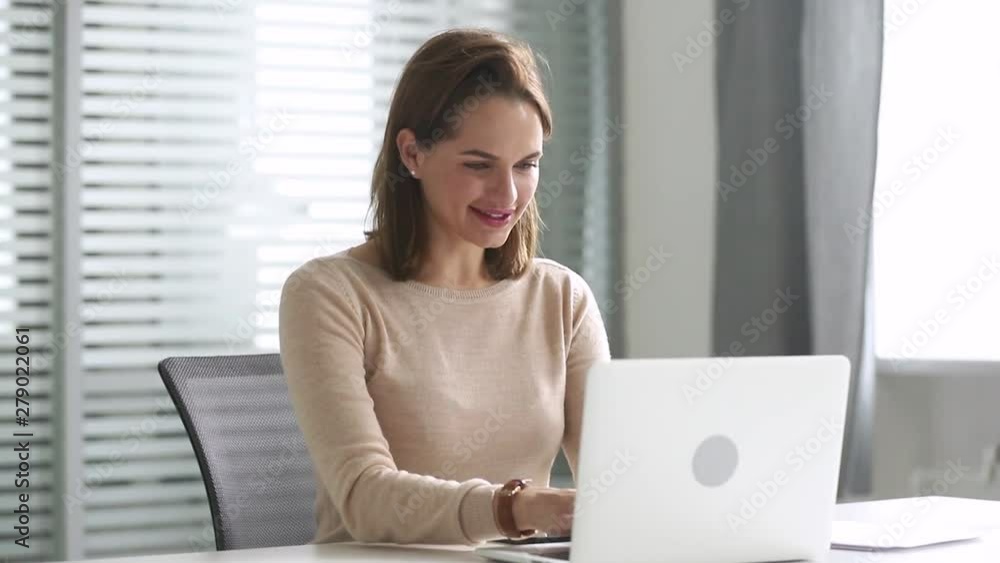 Happy business woman using computer communicating online sitting at desk Happy business woman using computer communicating online sitting at desk