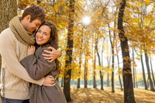love  relationship  family and people concept - smiling couple hugging in autumn park