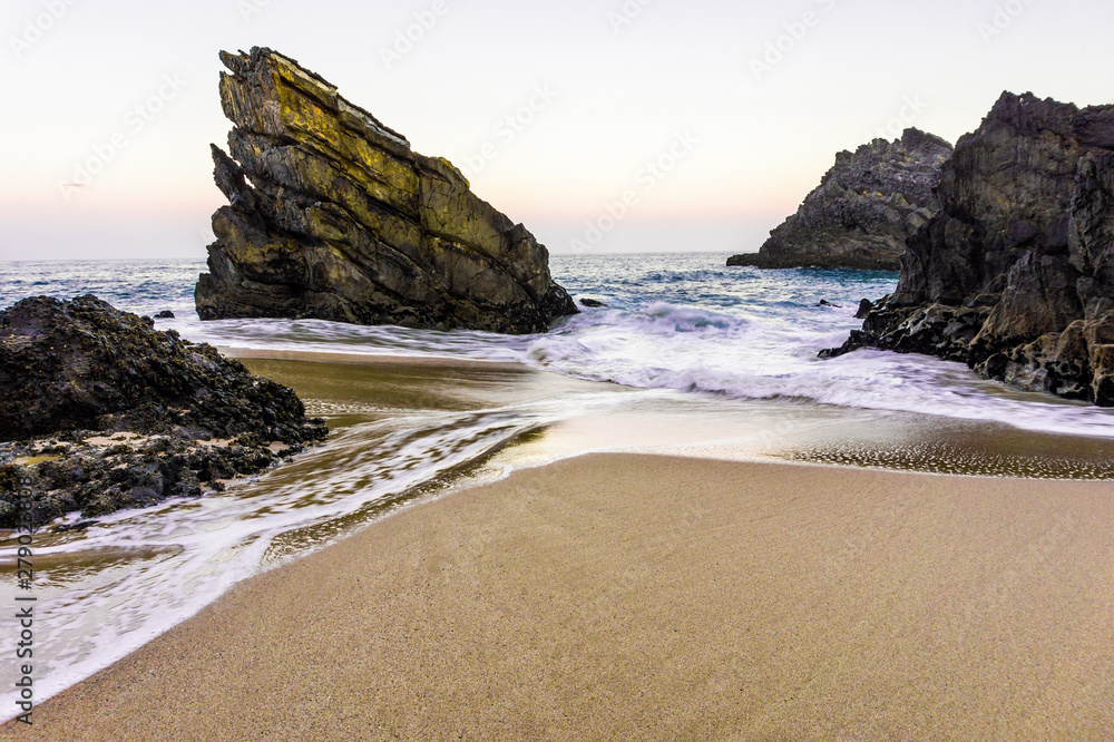 Beautiful sandy beach with rocks on Atlantic coast, Portugal Beautiful sandy beach with rocks on Atlantic coast, Portugal