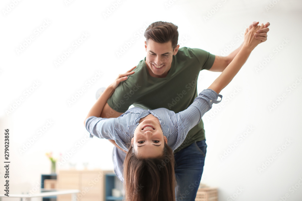 Beautiful young couple dancing indoors Beautiful young couple dancing indoors
