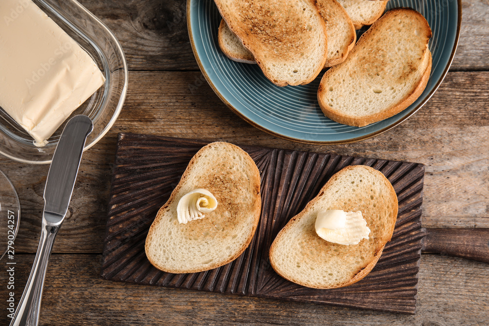 Flat lay composition with bread and butter on wooden table Flat lay composition with bread and butter on wooden table