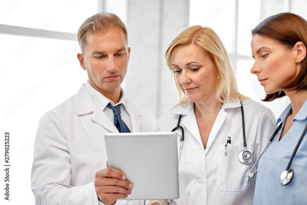 healthcare, medicine and technology concept - group of doctors with tablet computer at hospital healthcare, medicine and technology concept - group of doctors with tablet computer at hospital