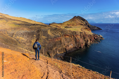 Fototapeta Naklejka Na Ścianę i Meble -  Tourist walking on a trekking path at Ponta de Sao Lourenco, Madeira