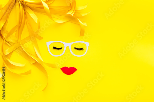 Make up concept with face model for visagiste work on yellow background top view mockup