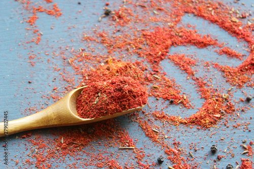 Spices in a wooden spoon. Various Indian spices on black stone table. Spices and herbs on a slate background. Ingredients For cooking. Copy space.