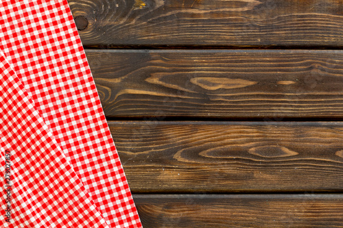 blog design with picnic tablecloth on wooden background top view copy space