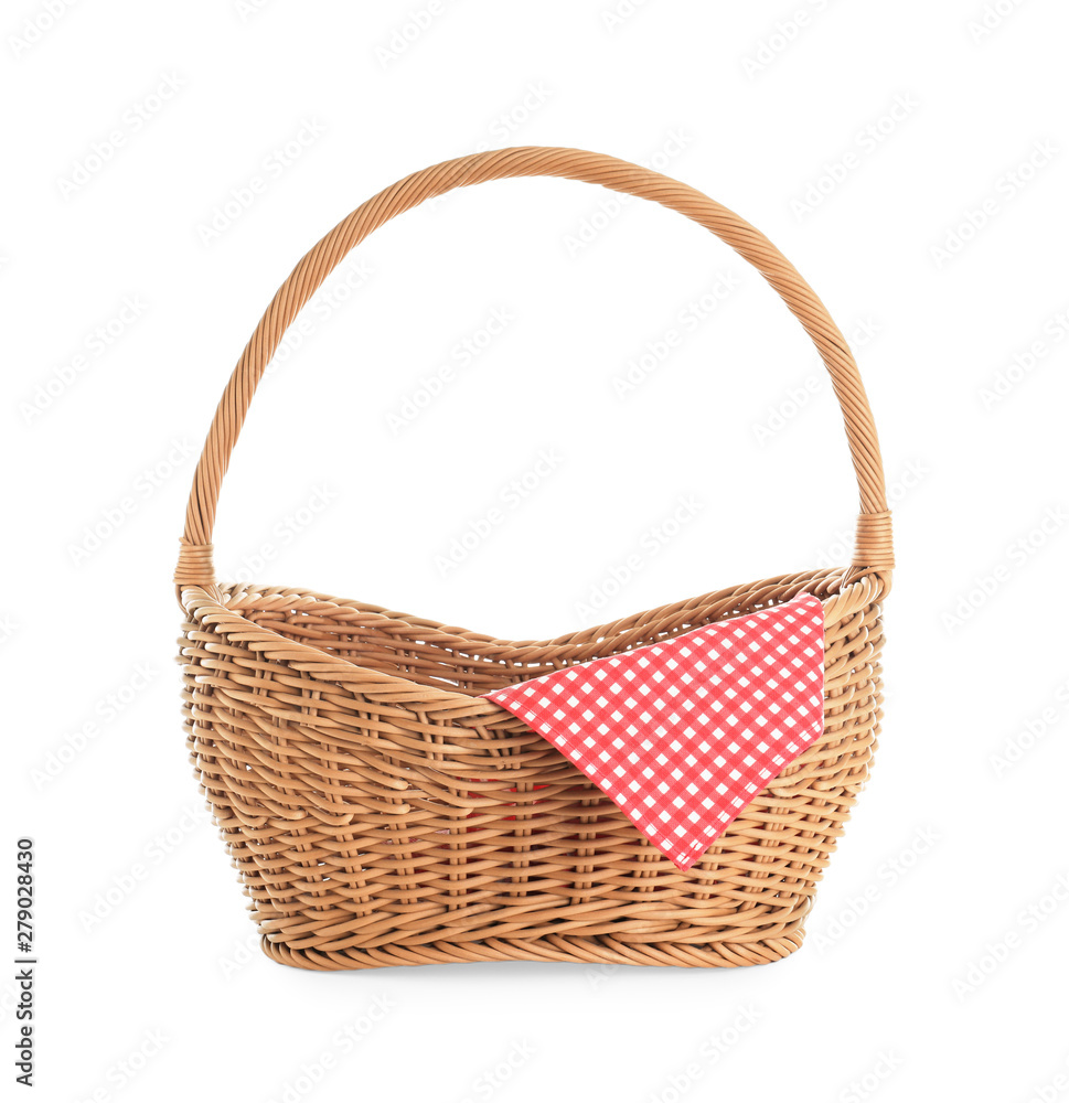 Wicker picnic basket with checkered tablecloth on white background Wicker picnic basket with checkered tablecloth on white background