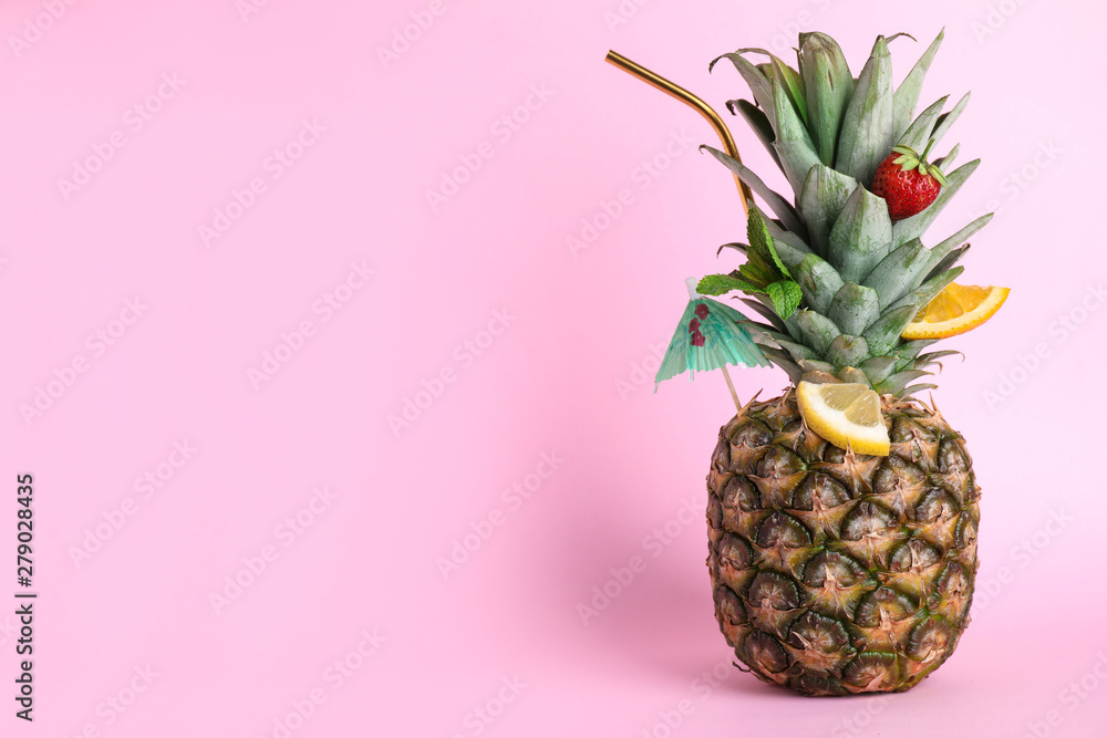 Fototapeta Fresh pineapple decorated with fruits and straw as summer cocktail on color background, space for text