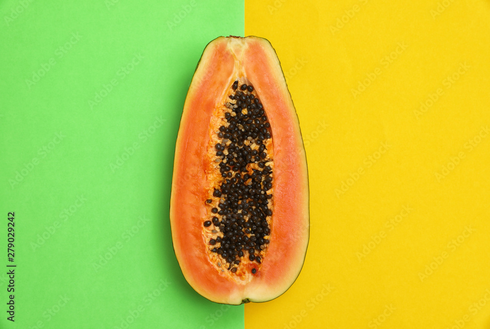 Fresh juicy halved papaya on color background, top view Fresh juicy halved papaya on color background, top view