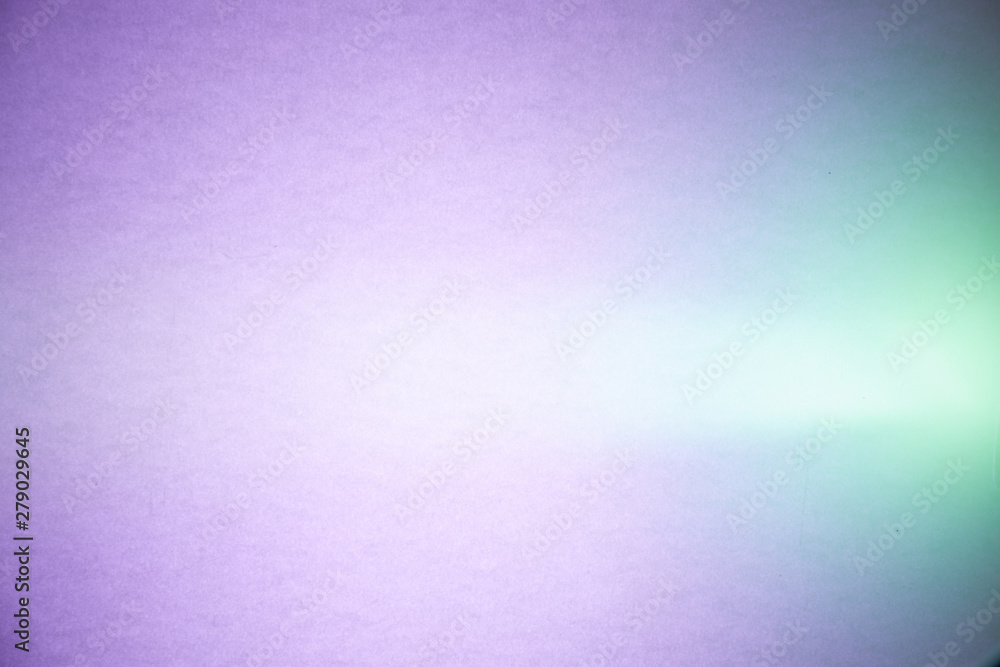 Light ray of light in the middle of purple textural and turquoise semi-blurred background