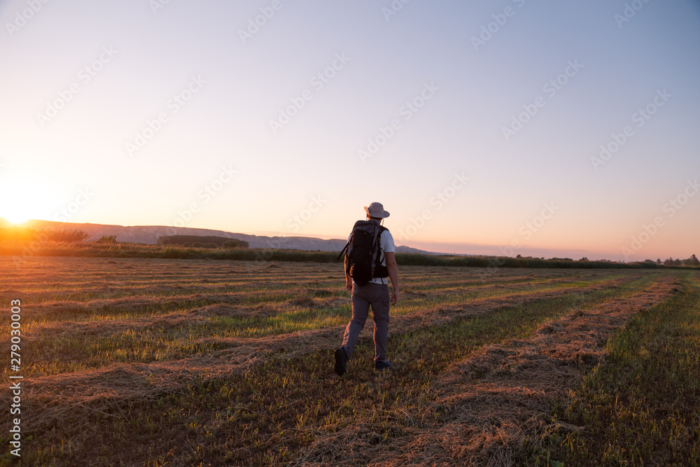 backpacker traveler walking at sunrise