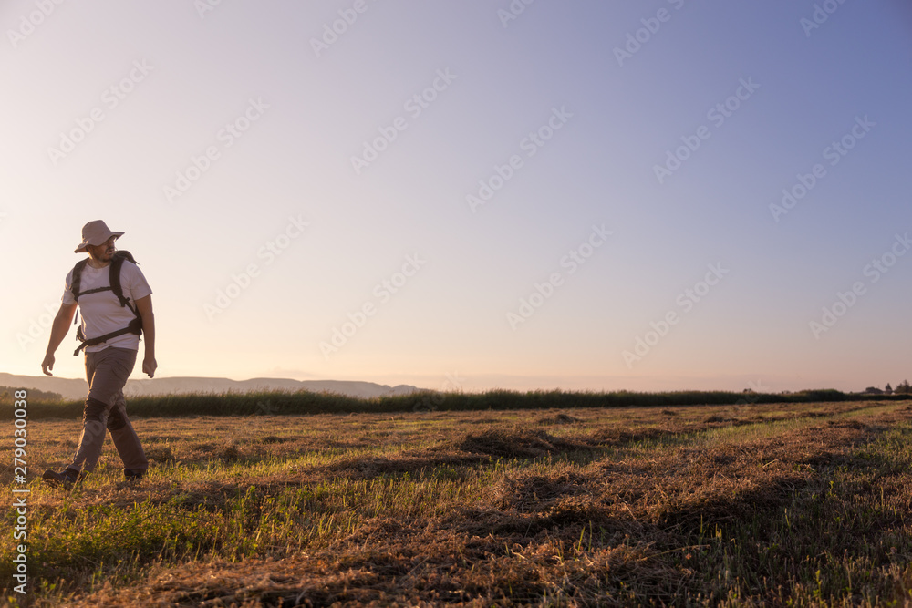 backpacker traveler walking at sunrise