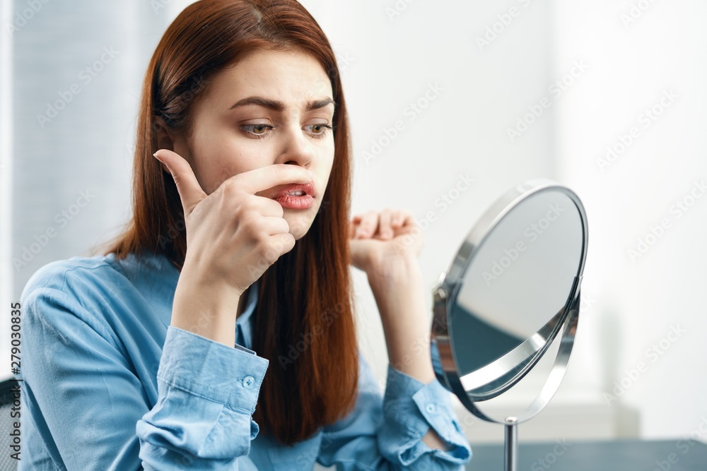 young woman looking through a magnifying glass young woman looking through a magnifying glass