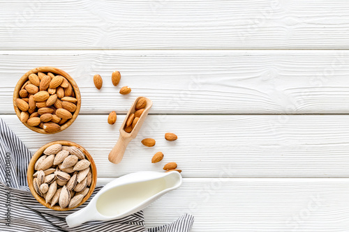 almond for cooking milk on white wooden background top view mockup