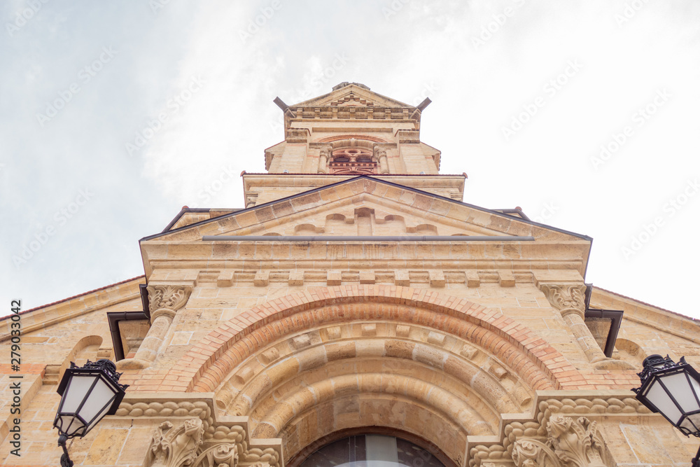 The building is made of natural sandstone. Facade of a catholic temple bottom view.