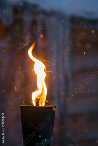 Fire burning inside metal torch photo