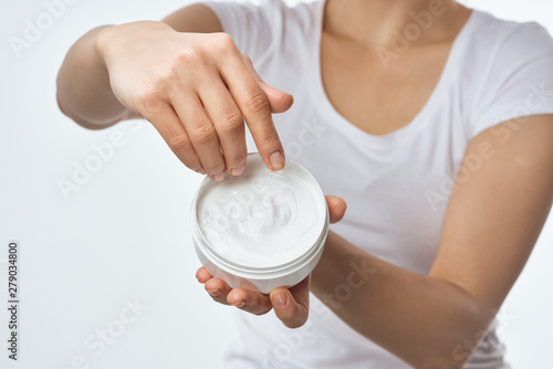 woman hands with cosmetic cream