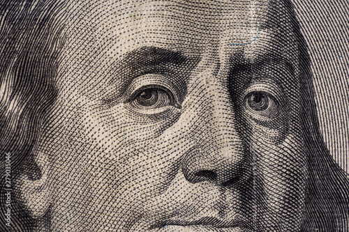 A fragment of a bill of 100 US dollars. Portrait of Benjamin Franklin.