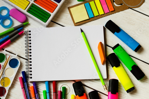 School and office supplies on a wooden table
