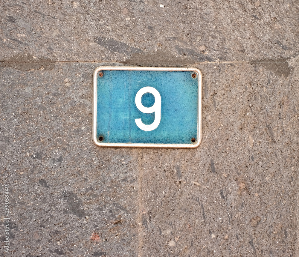9, nine - light blue plate on gray stone surface. 9, nine - light blue plate on gray stone surface.
