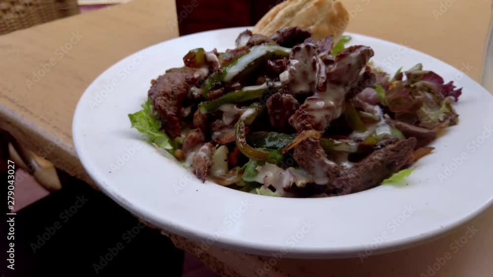 Tenderloin Salad on a white plate – camera circling plate - close up Tenderloin Salad on a white plate – camera circling plate - close up