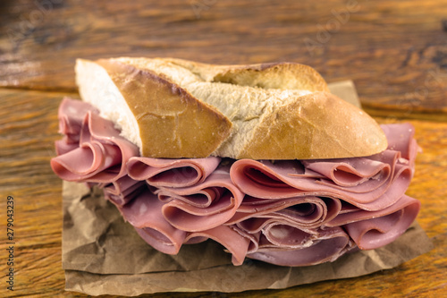 Traditional mortadella sandwich. Salt bread with bologna. Great snack of pork with bread, typical of Brazil. photo