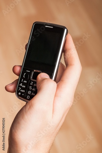 Wallpaper Mural Person holding a cell phone Torontodigital.ca