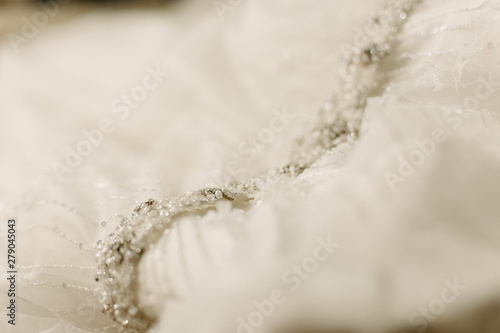 Detail of the fabric of a white wedding dress.