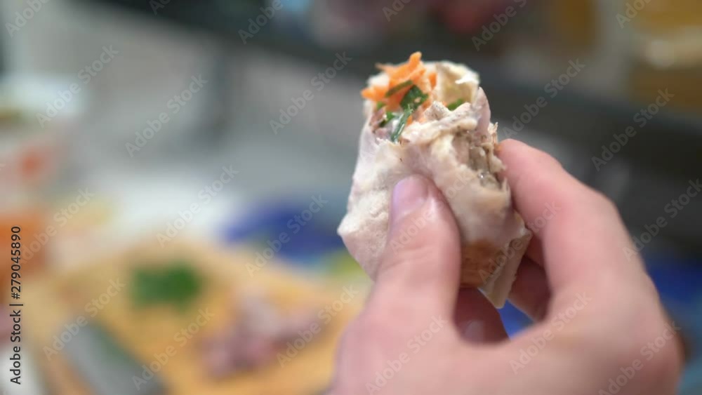 close-up. A man eats shawarma at home in the kitchen close-up. A man eats shawarma at home in the kitchen