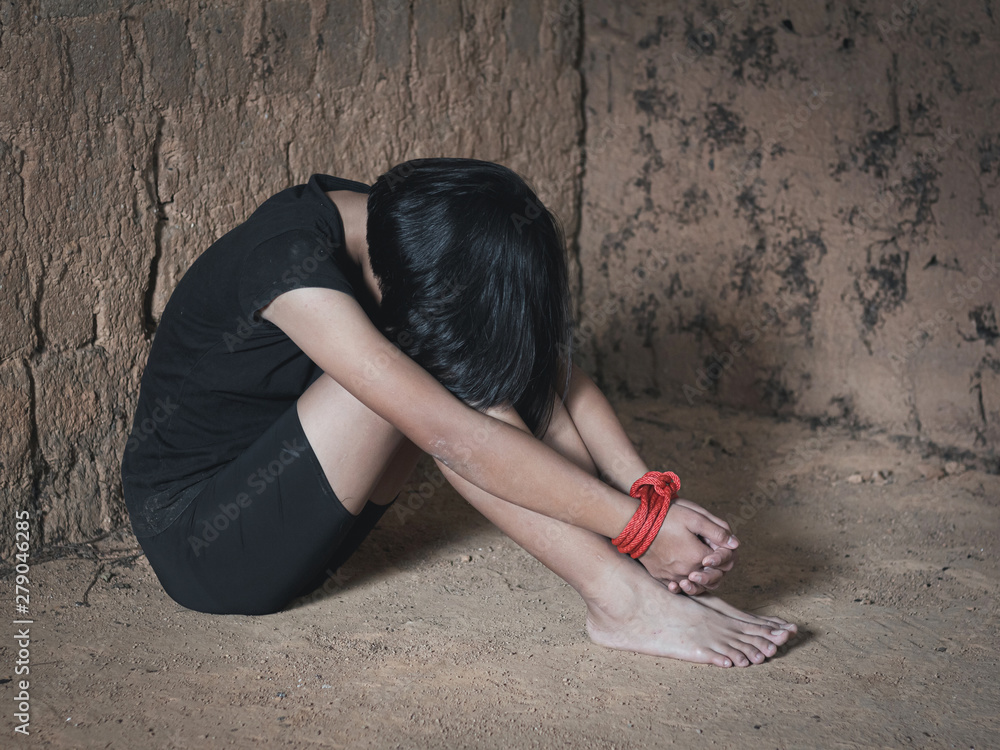 A victim tied up with rope. Human trafficking concept. Stock Photo ...