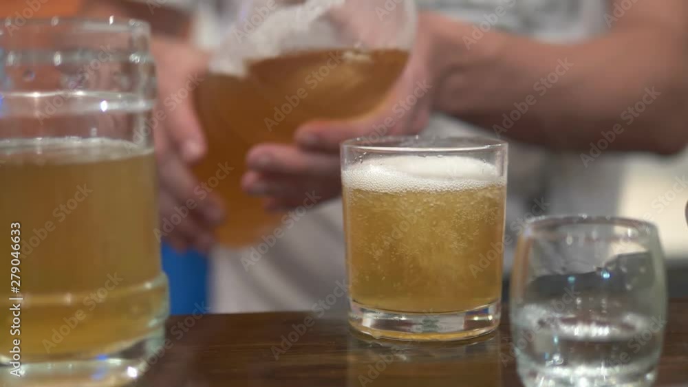 alcoholism concept, close-up, a man pours beer into a glass alcoholism concept, close-up, a man pours beer into a glass