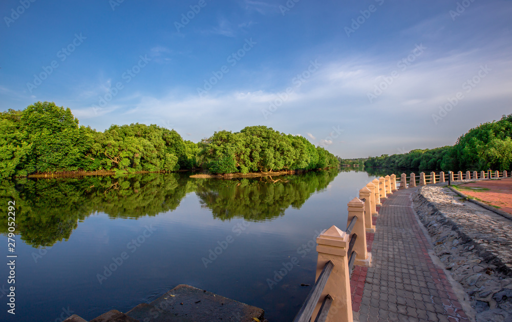Nature close-up background by the river, able to see the surrounding atmosphere (parks, mangroves, trees, sky, pagodas) that allow tourists or people to stop on the way and take public pictures.