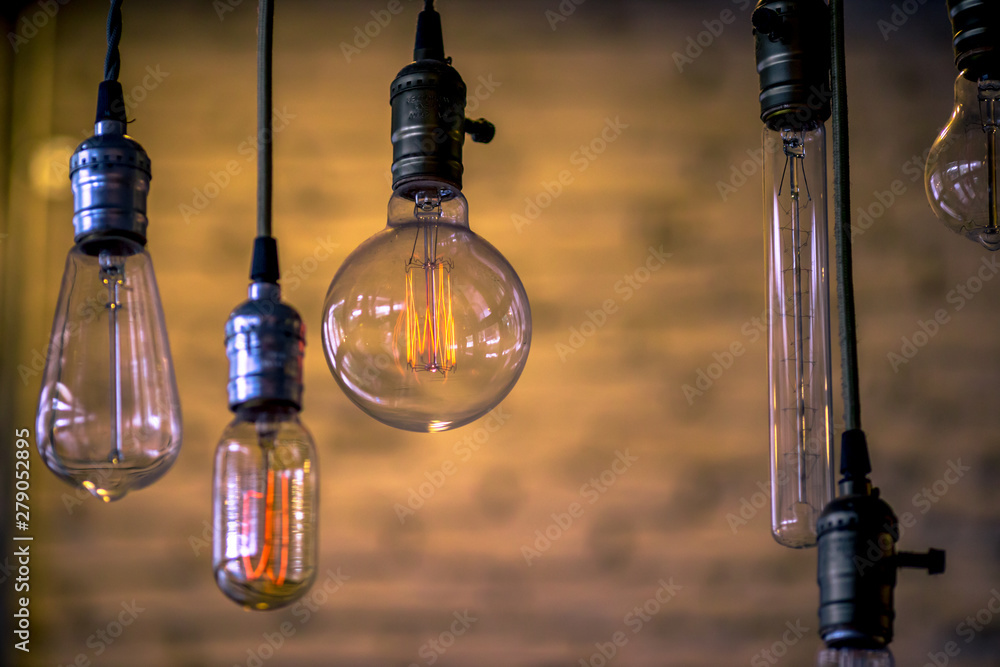 Beautiful hanged orange decoration light bulbs focus on pear shape like one in the coffee shop Beautiful hanged orange decoration light bulbs focus on pear shape like one in the coffee shop