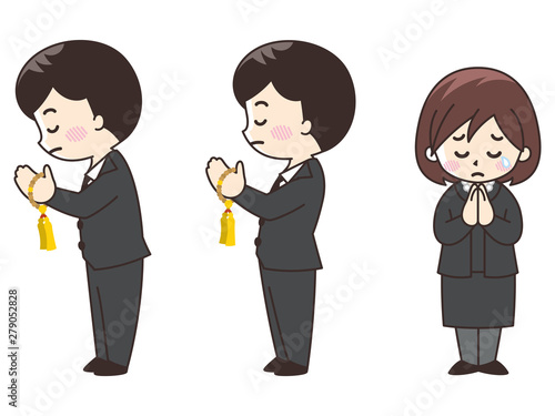 手を合わせる礼服を着た男女