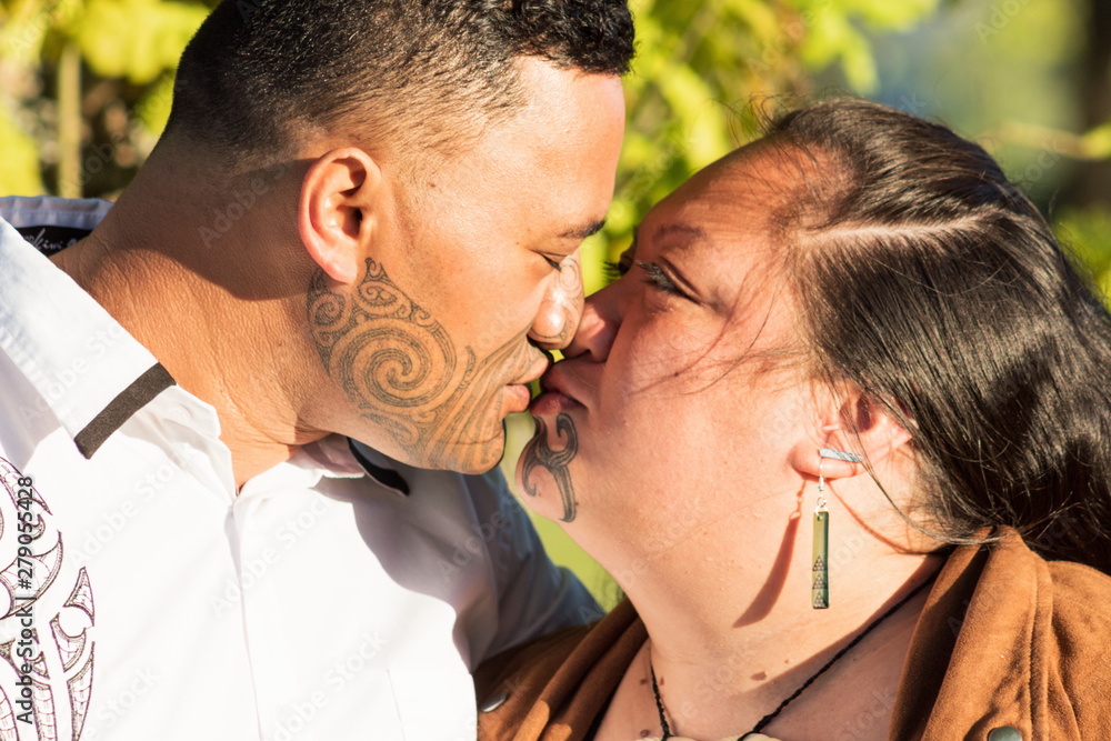 Fototapeta premium Portrait of an attractive Maori couple kissing taken outdoors