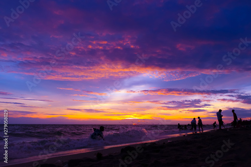 the twilight sky over the sea and silhououng people on the beachette of y for baclground, colorful of the sky in the summer © Kenstocker
