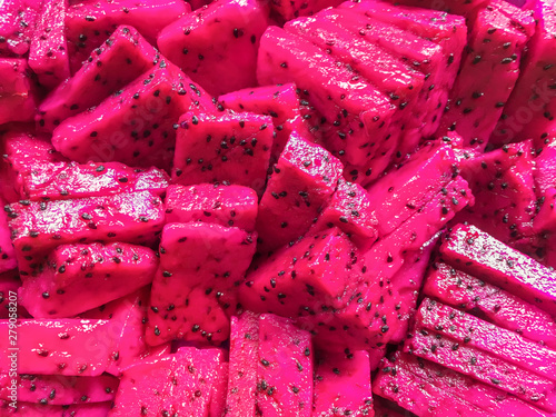 Ripe juicy sliced of pink pitaya. Tropical fruit backgroound photo