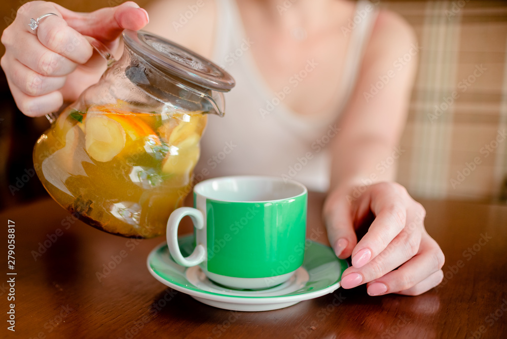 Female hands hold hot green coffee cup beverage, drinks cappuccino. Horizontal several objects copyspace Female hands hold hot green coffee cup beverage, drinks cappuccino. Horizontal several objects copyspace