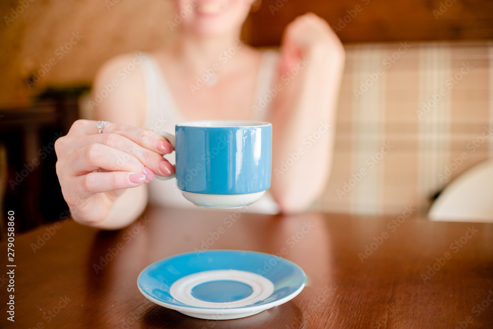 Female hands hold hot green coffee cup beverage, drinks cappuccino. Horizontal several objects copyspace Female hands hold hot green coffee cup beverage, drinks cappuccino. Horizontal several objects copyspace
