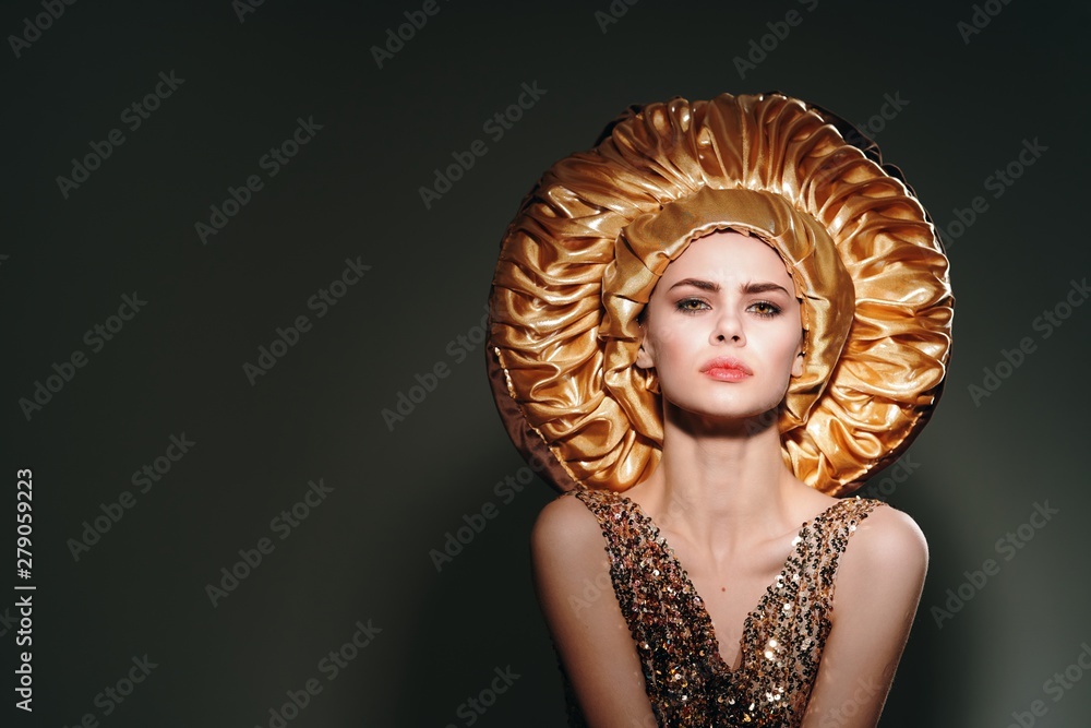 Beautiful woman in golden masquerade dress