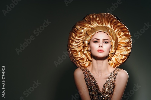 Beautiful woman in golden masquerade dress