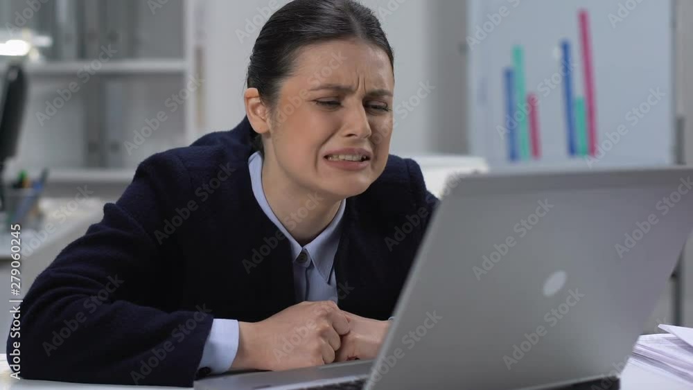 Worried young woman working laptop, complicated work mistake, difficulties Worried young woman working laptop, complicated work mistake, difficulties