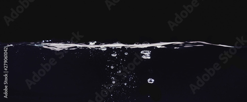 Water bubbles isolated on black background, close up view. Rippling liquid surface, an abstract background for overlays design, screen blending mode layer