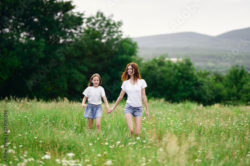 happy mother and daughter in the field