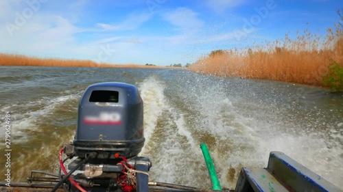 Hot spring on the Volga River. Russia, Astrakhan region, near the town of Kamyzyak. View from the stern of a motorboat going along the Volga river channel. photo