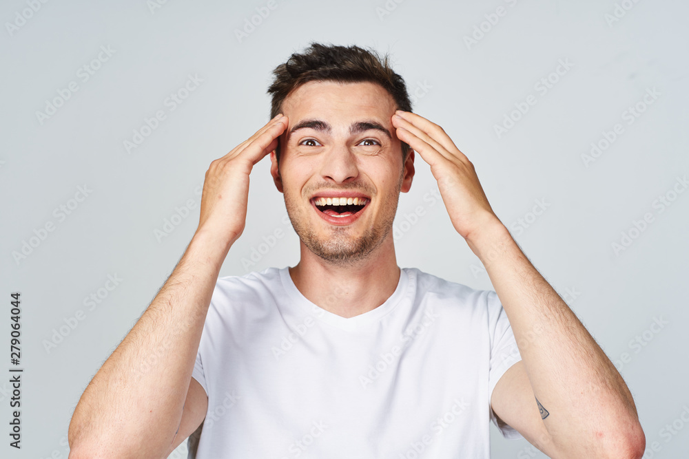 portrait of a man with hands on his head portrait of a man with hands on his head