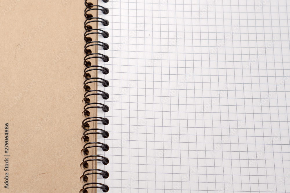 Notebook with checkered sheets. Top view. Close-up Notebook with checkered sheets. Top view. Close-up