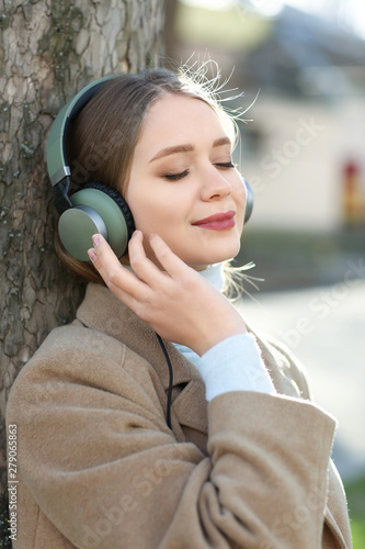 Beautiful young woman liste...