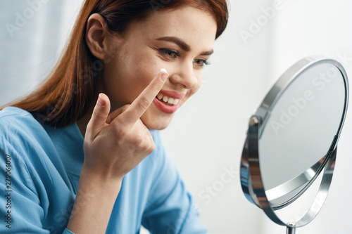 woman looking through a magnifying glass